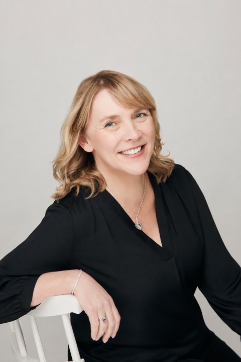 Michelle Lentz smiling, seated in a black shirt